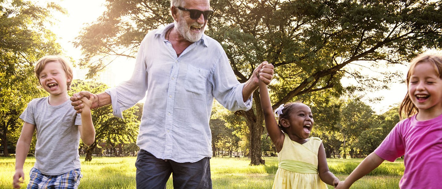 Senior holding children's hands