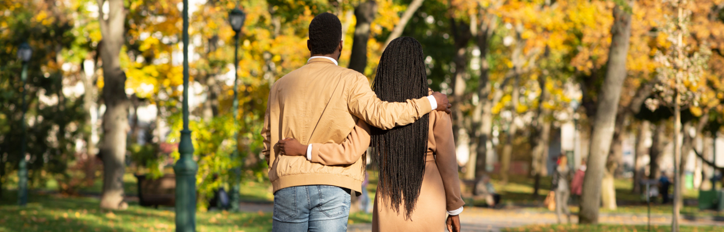 Couple with arms around each other