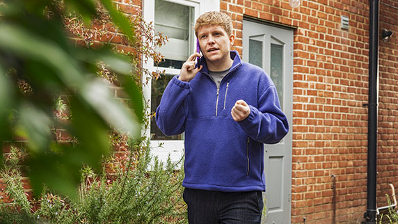 Young man on phone outdoors
