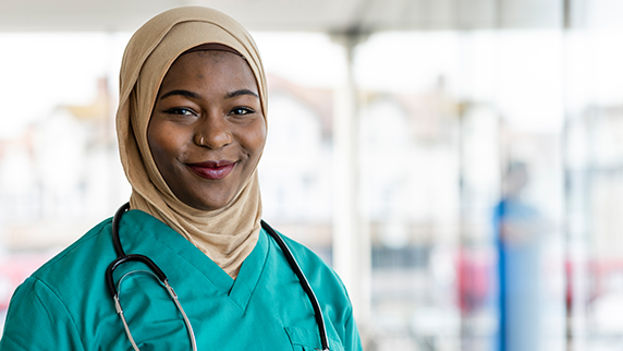 Doctor with stethoscope smiling at camera