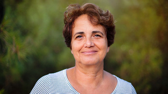 Woman against green background