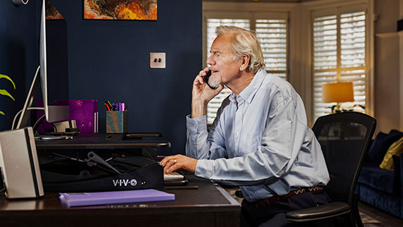 Man on laptop in home office