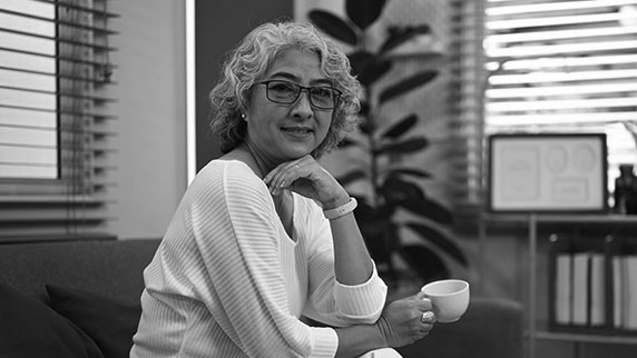 Lady on sofa with tea cup