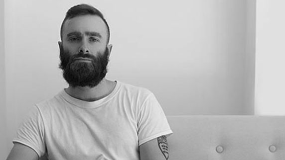 Man with beard in beige room