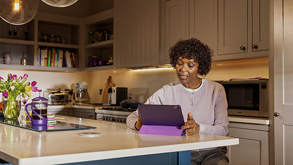 Woman with tablet in kitchen