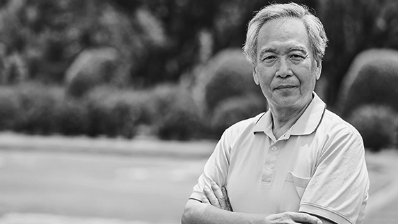 Man with arms folded looking at camera